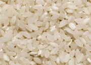 Detailed close-up image of raw organic white rice grains showcasing texture and abundance.