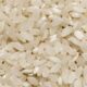 Detailed close-up image of raw organic white rice grains showcasing texture and abundance.