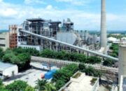 Tumpukan gulungan kertas besar di fasilitas produksi pabrik kertas industri.